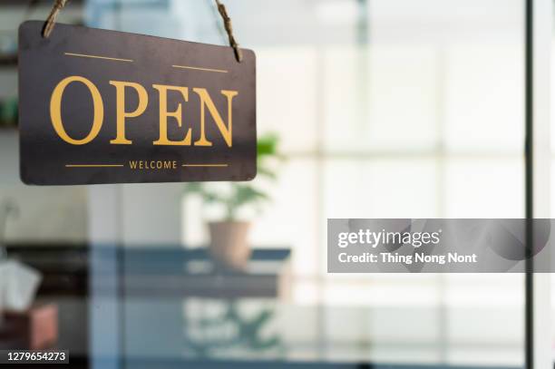 store open sign hanging on the window - bord open stockfoto's en -beelden