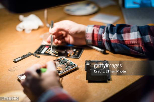 young man repairing smartphone, diy - e waste stock pictures, royalty-free photos & images