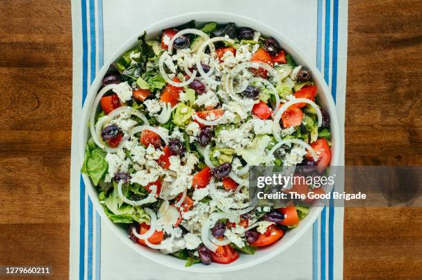 overhead view of traditional greek salad on table - greek salad stock pictures, royalty-free photos & images