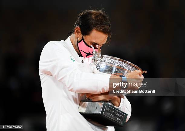 Rafael Nadal of Spain hugs the winners trophy following victory in his Men's Singles Final against Novak Djokovic of Serbia on day fifteen of the...
