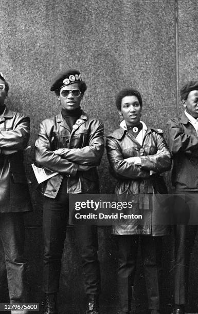 View of several Black Panther Party members as they demonstrate, arms folded, outside the New York County Criminal Court , New York, New York, April...