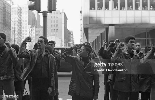 View of Black Panther Party members as they demonstrate, fists raised, on Centre Street , New York, New York, April 11, 1969. The demonstration was...