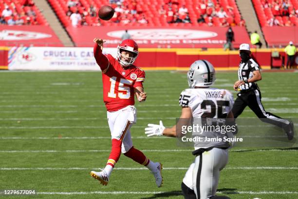 Patrick Mahomes of the Kansas City Chiefs throws a touchdown pass Sammy Watkins , under pressure from Erik Harris of the Las Vegas Raiders during the...