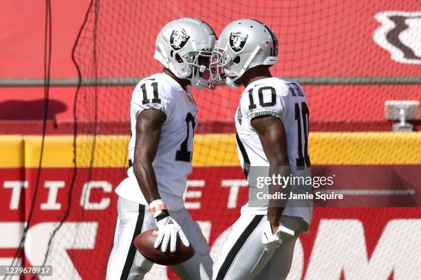 Henry Ruggs III of the Las Vegas Raiders is congratulated by Rico Gafford after a 72-yard touchdown reception against the Kansas City Chiefs during...