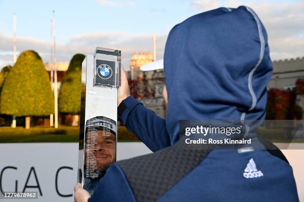 Tyrrell Hatton of England wearing his hoodie and holding the winners trophy after the final round of the BMW PGA Championship at Wentworth Golf Club...