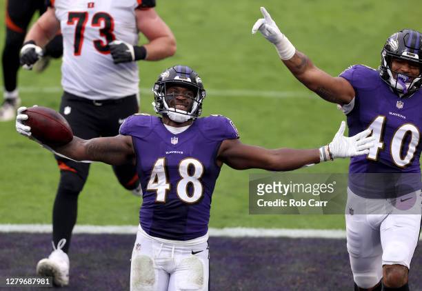 Inside linebacker Patrick Queen of the Baltimore Ravens celebrates with teammate linebacker Malik Harrison after returning a fumble for a fourth...