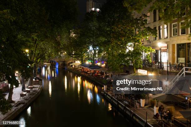 restaurants along the utrecht old canal in the evening - cellar stock pictures, royalty-free photos & images