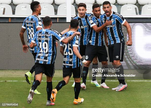 Diego Souza of Gremio celebrates with his team mates after scoring the first goal of their team during the match against Santos as part of...