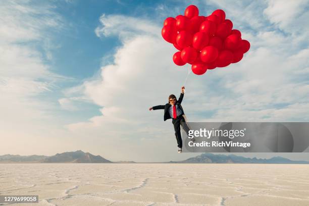 joven business boy con globos - flying solo fotografías e imágenes de stock