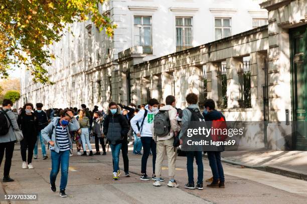 high school student in front of the high school entrance - secondary school covid stock pictures, royalty-free photos & images