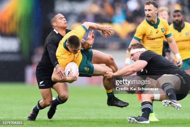 James O'Connor of the Wallabies is tackled by Aaron Smith of the All Blacks and Sam Cane of the All Blacks during the Bledisloe Cup match between the...