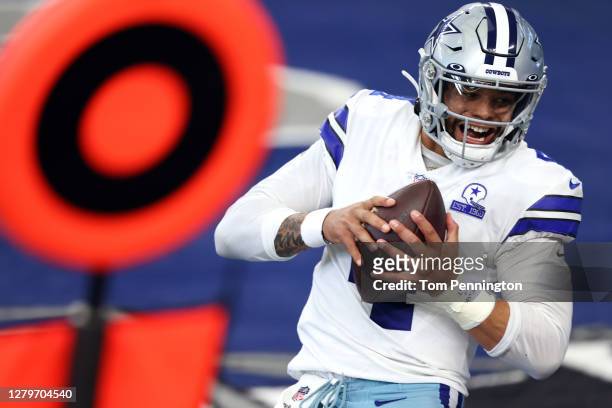 Dak Prescott of the Dallas Cowboys catches a touchdown pass against the New York Giants during the second quarter at AT&T Stadium on October 11, 2020...