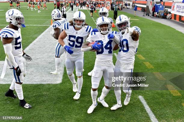 Isaiah Rodgers of the Indianapolis Colts celebrates with teammates after returning a kickoff for a touchdown in the third quarter against the...