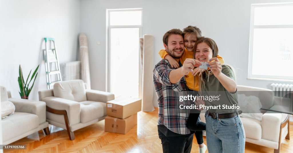 Holding keys of their new home