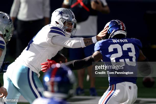 Dak Prescott of the Dallas Cowboys runs the ball against Logan Ryan of the New York Giants as he sustains an ankle injury during the third quarter at...