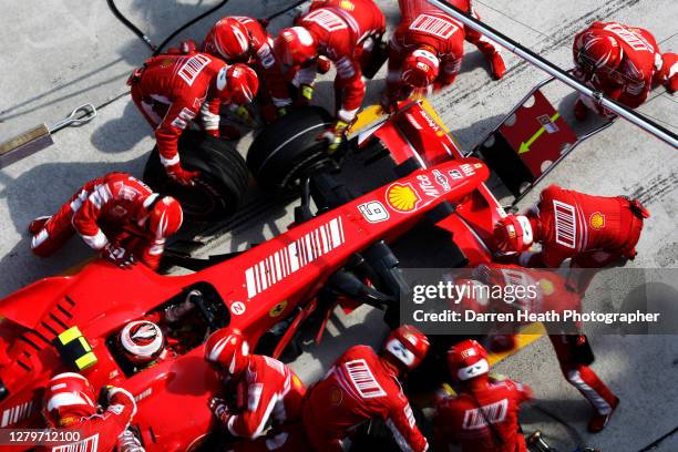 Finnish Ferrari Formula One driver Kimi Raikkonen in his F2007 car during a fuel and tyre pit stop with his Ferrari mechanics during the 2007...