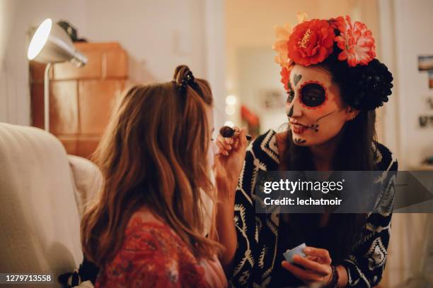 maman mettant le maquillage sur sa fille pour le jour de la célébration morte - young goth girls photos et images de collection