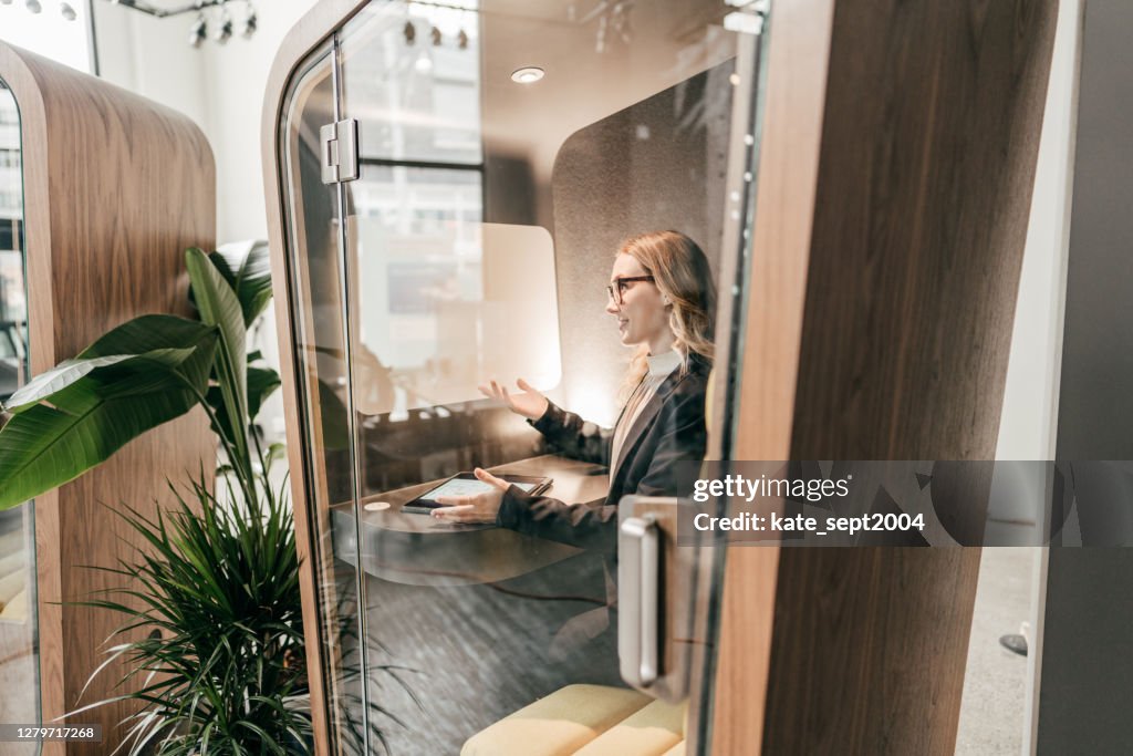 Caucasian woman on her video chat with online team