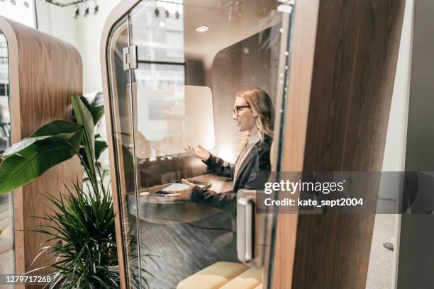 caucasian woman on her video chat with online  team - telephone booth stock pictures, royalty-free photos & images