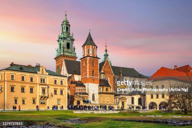 sunset with the wawel cathedral, clock tower and sigismund's chapel on the wawel hill, krakow, poland - wawel cathedral stock pictures, royalty-free photos & images