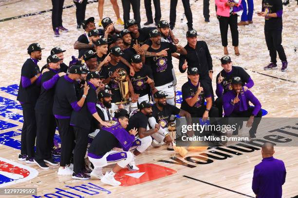 The Los Angeles Lakers pose for a team photo with the trophy after winning the 2020 NBA Championship over the Miami Heat in Game Six of the 2020 NBA...