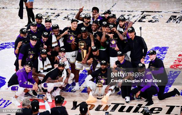 The Los Angeles Lakers pose for a team photo with the trophy after winning the 2020 NBA Championship over the Miami Heat in Game Six of the 2020 NBA...