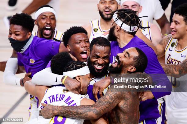 LeBron James of the Los Angeles Lakers celebrates with Quinn Cook of the Los Angeles Lakers and teammates after winning the 2020 NBA Championship in...