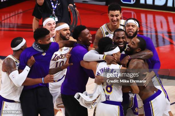 LeBron James of the Los Angeles Lakers celebrates with Quinn Cook of the Los Angeles Lakers and teammates after winning the 2020 NBA Championship in...