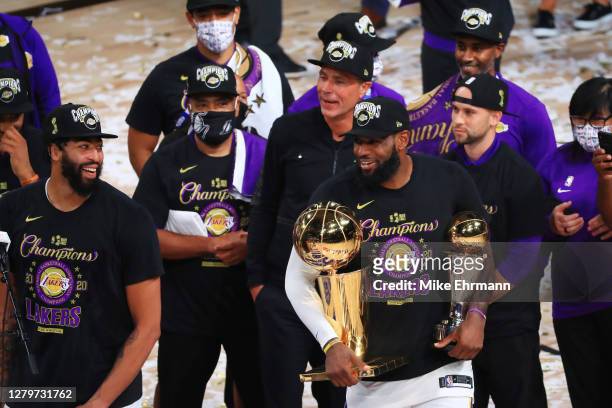 LeBron James of the Los Angeles Lakers reacts with his MVP trophy and Finals trophy after winning the 2020 NBA Championship over the Miami Heat in...
