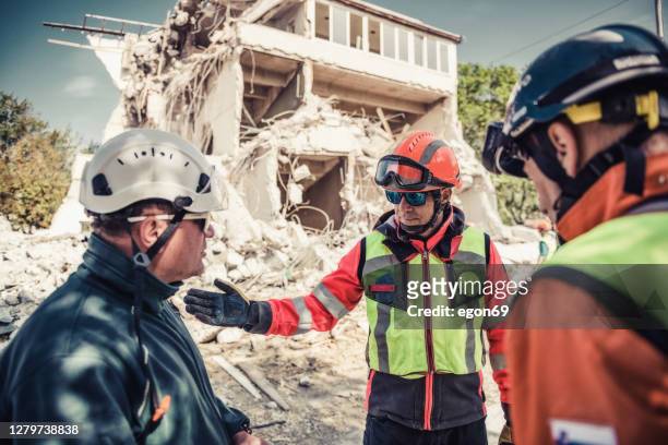 rescuer search trough ruins of building - social rehabilitation centre stock pictures, royalty-free photos & images