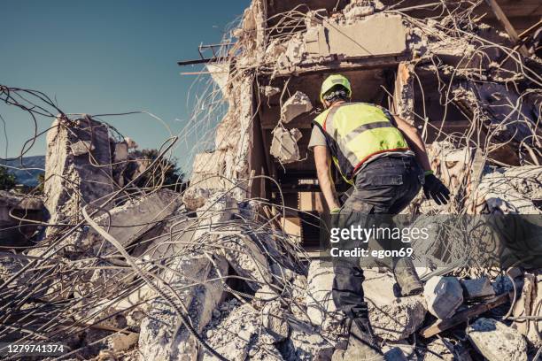 soccorritore ricerca attraverso rovine di edificio - damaged foto e immagini stock