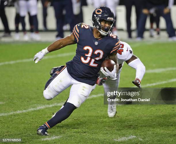 David Montgomery of the Chicago Bears breaks a run past Devin White of the Tampa Bay Buccaneers at Soldier Field on October 08, 2020 in Chicago,...