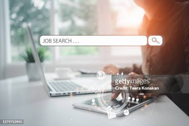 job search hiring website, young business man searching for job online a hand holding to touch a phone - en búsqueda fotografías e imágenes de stock