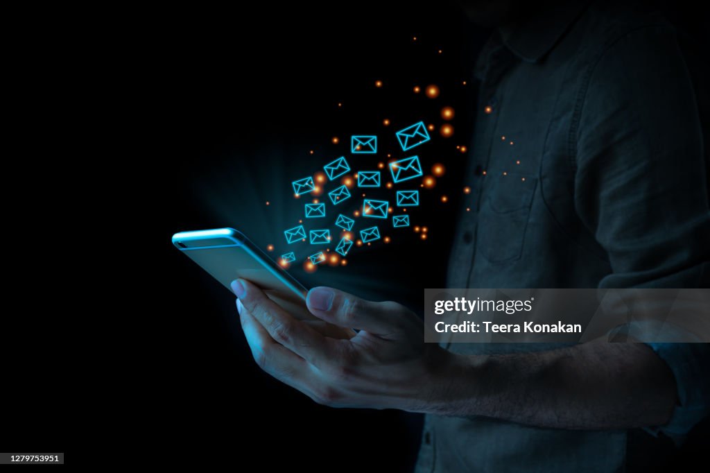 Close up of business man using mobile smart phone sending email