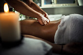 Young woman enjoying therapeutic  massage in spa