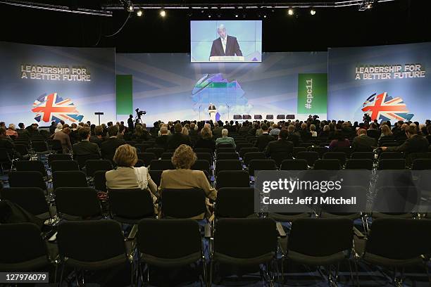 Delegates listen to Secretary of State for Health Andrew Lansley give his keynot speech in the auditorium during the Conservative Party Conference at...