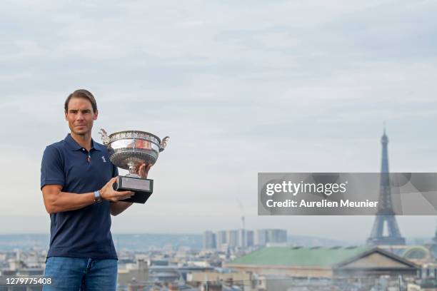 Rafael Nadal of Spain poses on the roof of Les Galeries Lafayette with Les Mousquetaires trophy following his victory in the Men's Singles Finals...