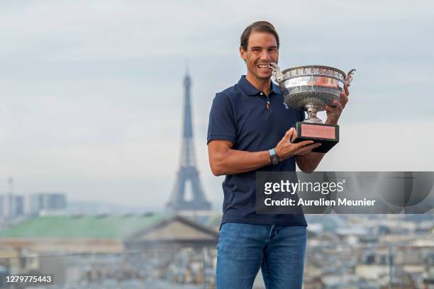 Rafael Nadal of Spain poses on the roof of Les Galeries Lafayette with Les Mousquetaires trophy following his victory in the Men's Singles Finals...