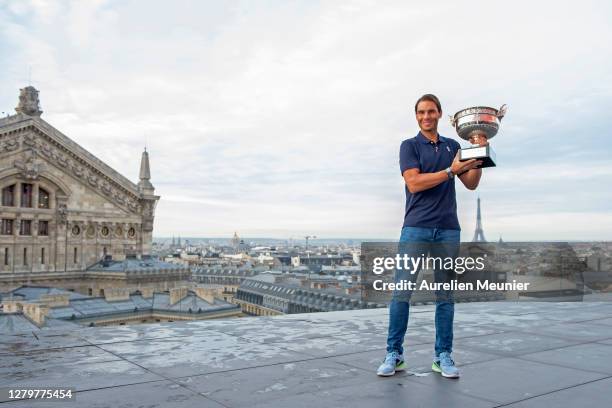 Rafael Nadal of Spain poses on the roof of Les Galeries Lafayette with Les Mousquetaires trophy following his victory in the Men's Singles Finals...