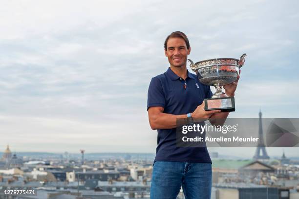 Rafael Nadal of Spain poses on the roof of Les Galeries Lafayette with Les Mousquetaires trophy following his victory in the Men's Singles Finals...