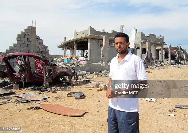 Elmehemed Agil stands before the rubble of his family's home, which was flattened by a NATO airstrike on Aug. 8. NATO contends it was a military...