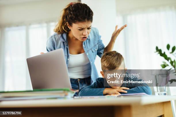 mother scolds a child for poor schooling and homework at home - furious child stock pictures, royalty-free photos & images