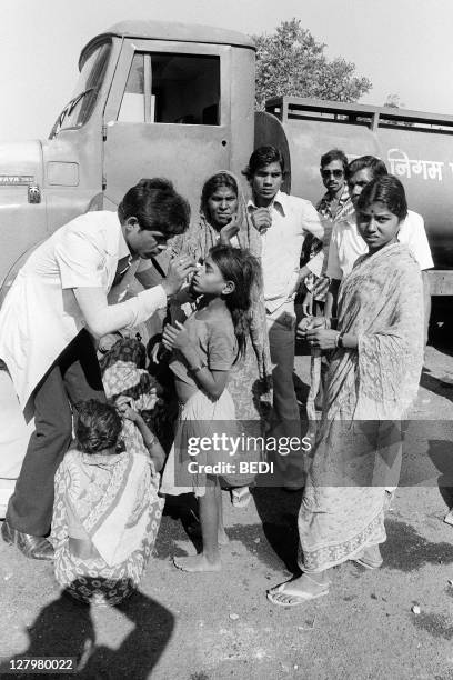 Blinded child, victim of the Bhopal tragedy, receives first aid to be treated for gas effects in eyes on December 04, 1984 in Bhopal where a poison...