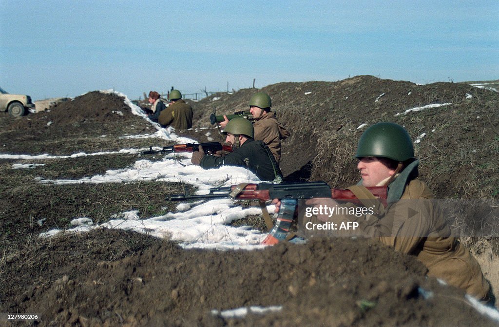 Chechen soldiers take positions in a tre
