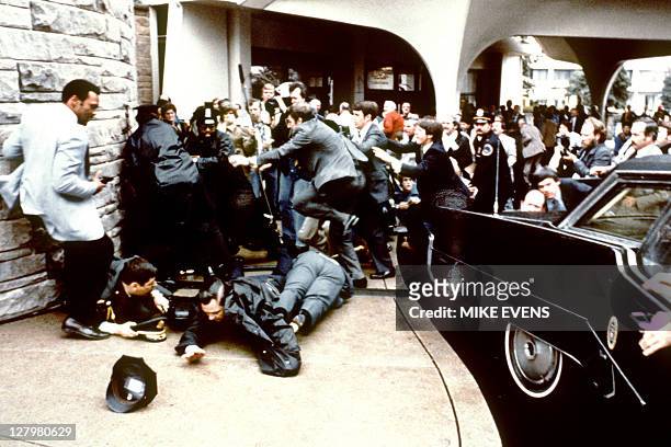This photo taken by presidential photographer Mike Evens on March 30, 1981 shows police and Secret Service agents reacting during the assassination...