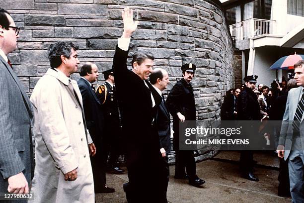 This photo taken by presidential photographer Mike Evens on March 30, 1981 shows President Ronald Reagan waving to the crowd just before the...