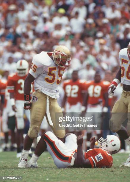 Marvin Jones, Linebacker for the Florida State Seminoles stands over Larry Jones, Running Back for the University of Miami Hurricanes after tackling...