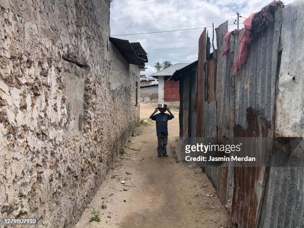 little boy in african village - africa immigration stockfoto's en -beelden