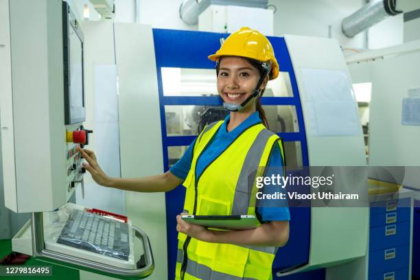 female mechanical engineer use tablet computer working with c.n.c. milling machine process. - n tech stock pictures, royalty-free photos & images