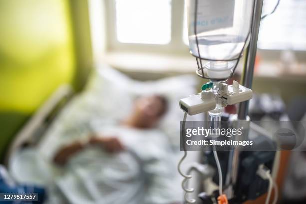 drip infusion of a patient in a hospital room. - iv infusion stock pictures, royalty-free photos & images